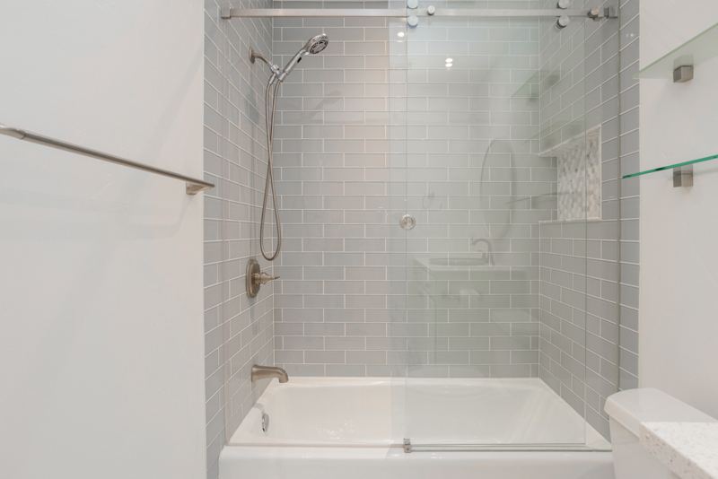Tiled shower and tub with glass doors