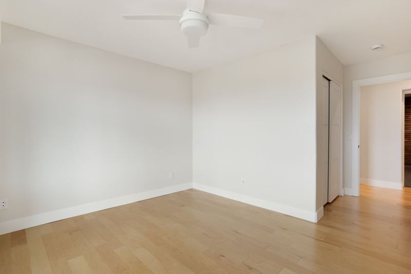 Bedroom with closet and hardwood floors
