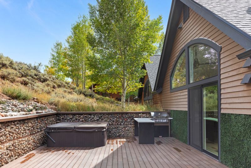 Private backyard patio with hot tub and built-in barbecue