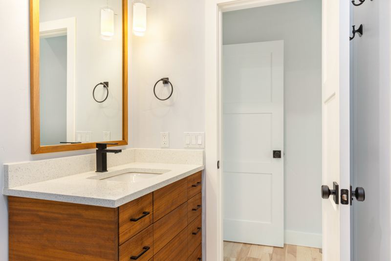 Bathroom with wood vanity and black fixtures