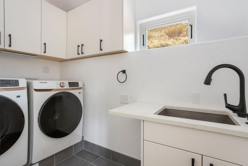 Laundry room with washer, dryer, and sink